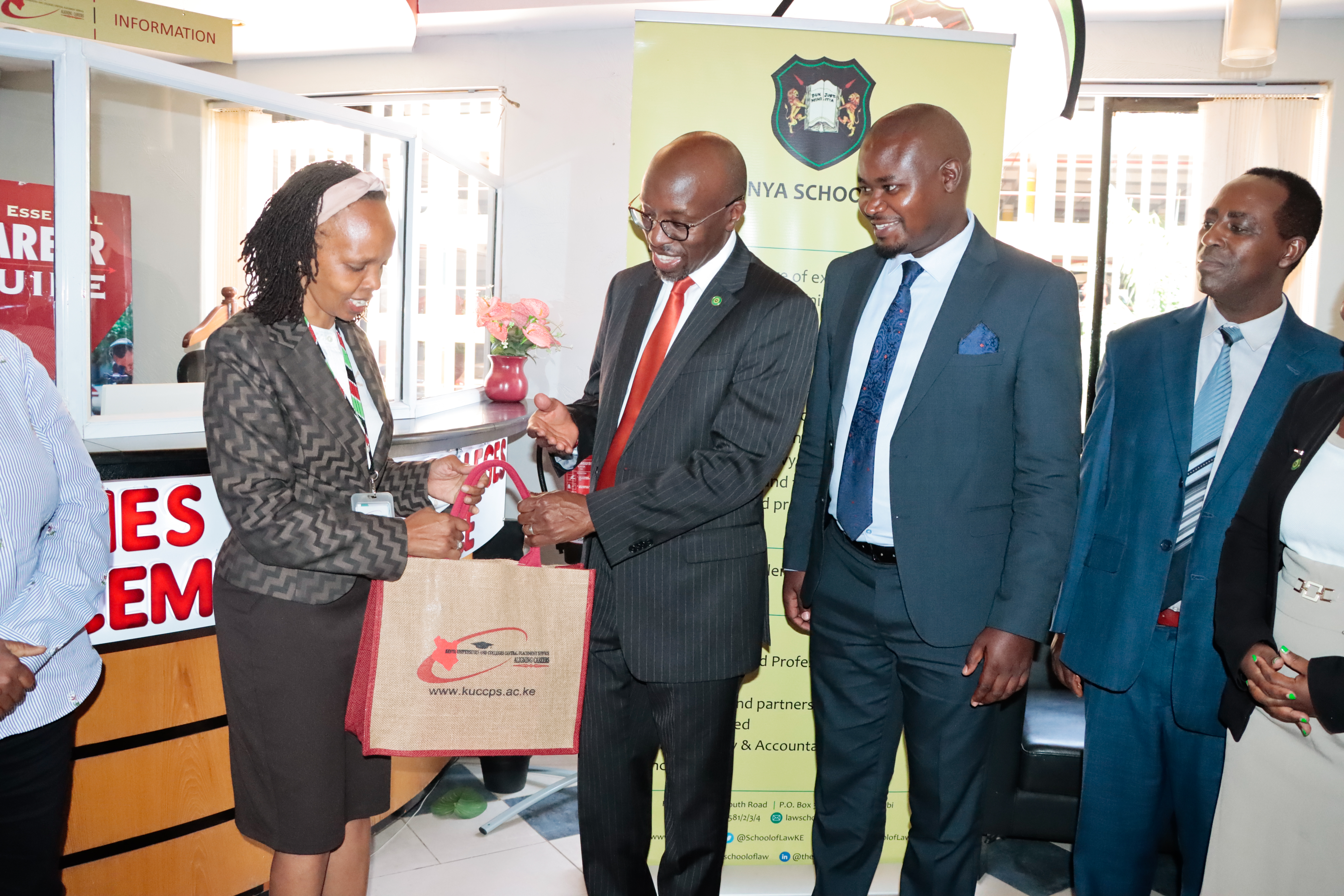 KUCCPS Chief Executive Officer Dr. Agnes Mercy Wahome hands a package to Kenya School of Law (KSL) Director Dr. Henry Mutai after they launched a partnership on February 10, 2025. The partnership is meant to enable applications for Kenya School of Law’s Diploma in Law Course through the KUCCPS portal, during the current course application window. With them are Mr. Gerald Gekombe, KSL’s Paralegal Training Programme Coordinator (3rd left) and Mr. Lawrence Ndirangu, Senior Academic Services Officer at KSL.